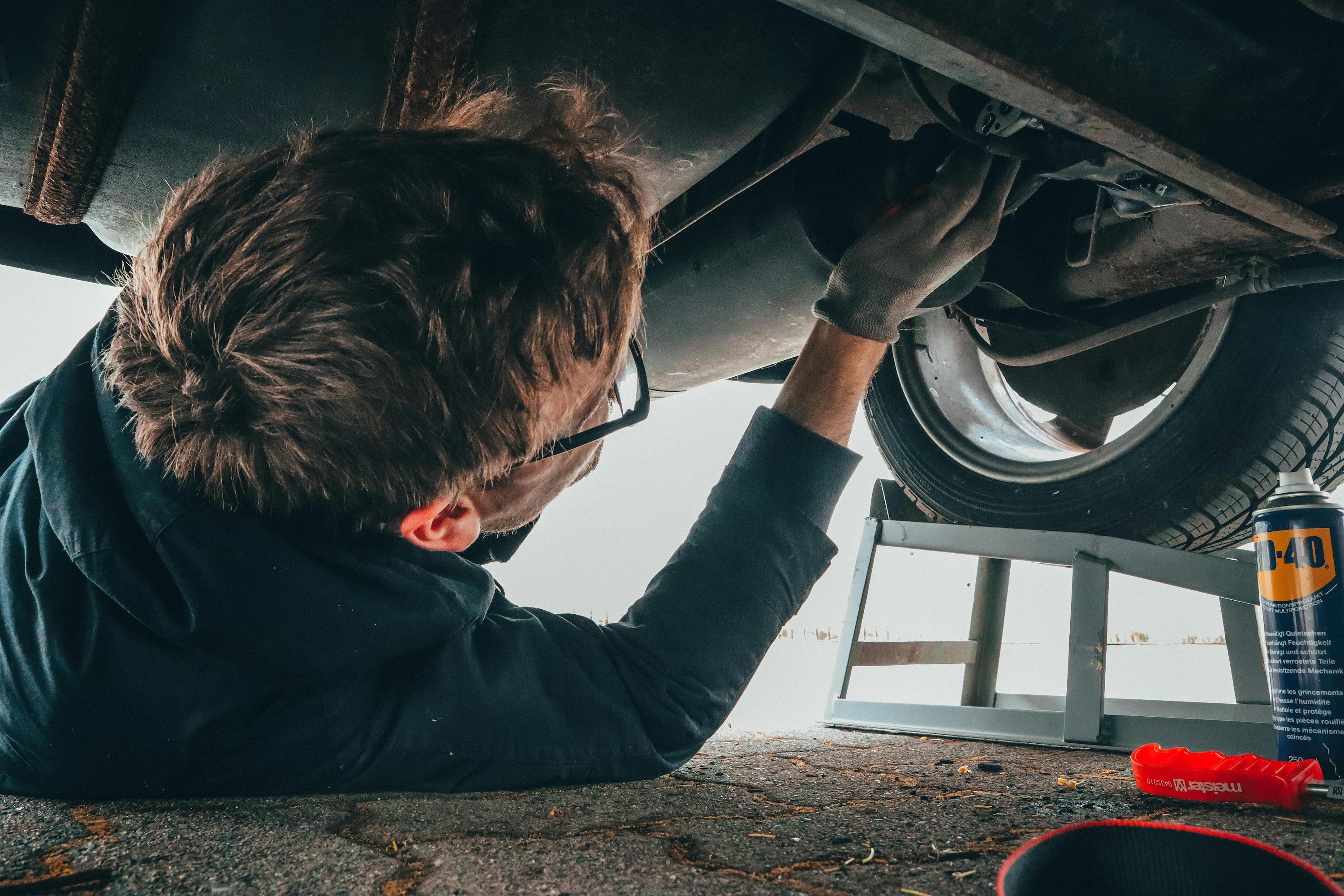 man opening oil valve in car